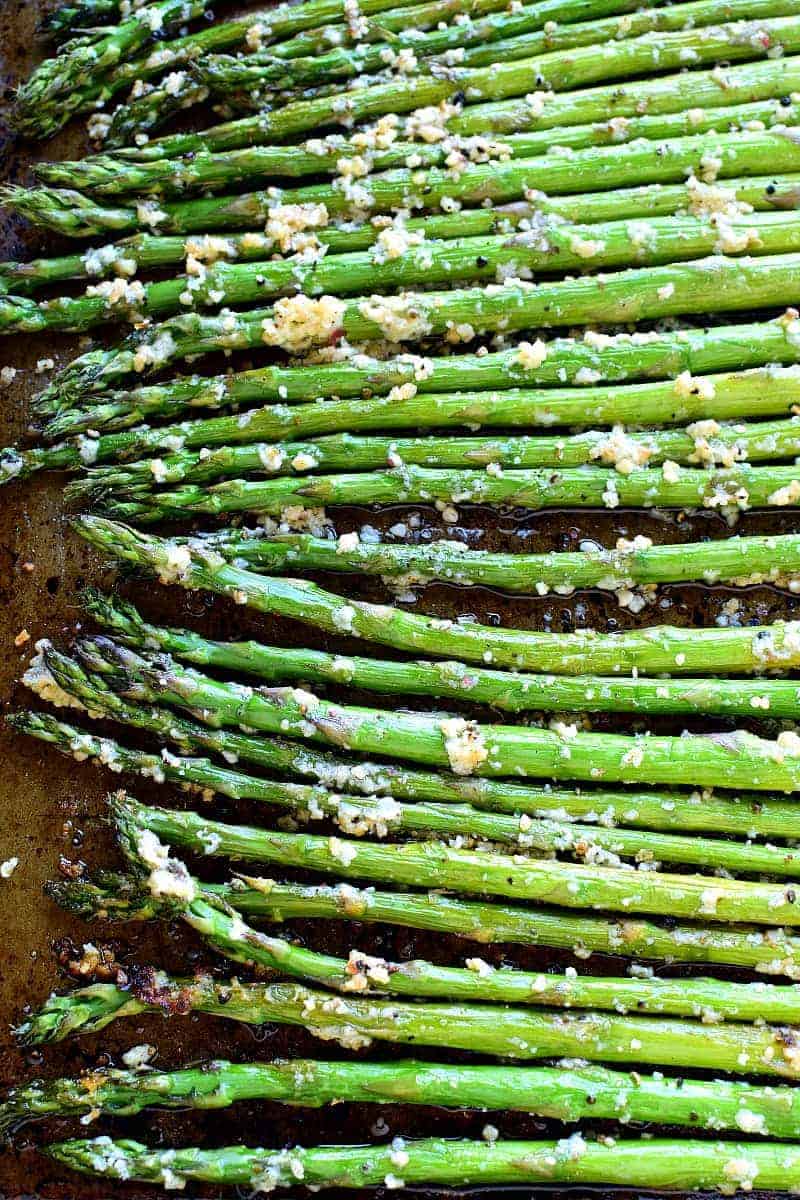 This Garlic Roasted Asparagus is packed with the delicious flavors of garlic and parmesan and is ready in 15 minutes or less!