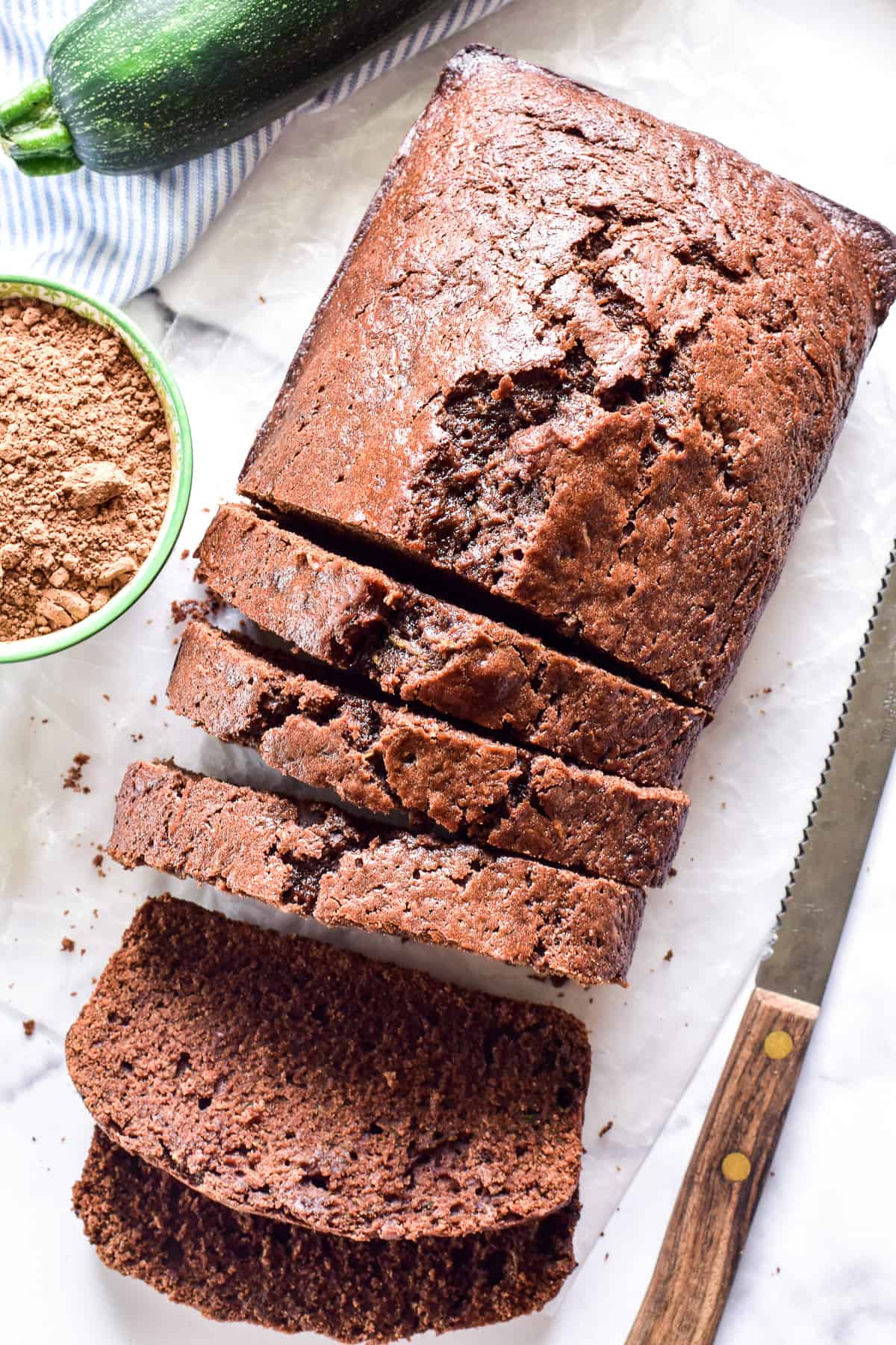 Overhead image of sliced Chocolate Zucchini Bread with a knife