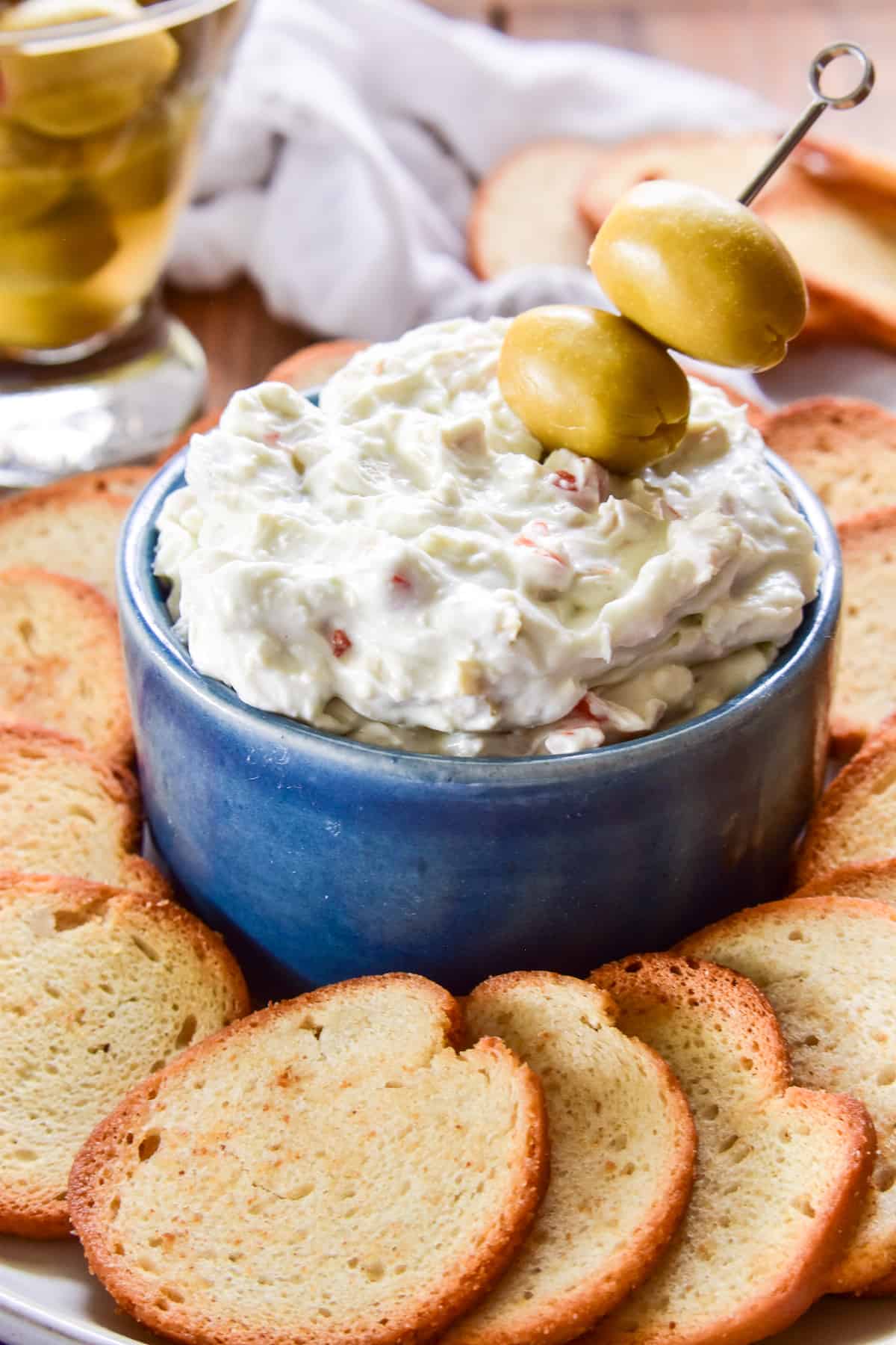 Dirty Martini Dip with olives and bagel chips for dipping